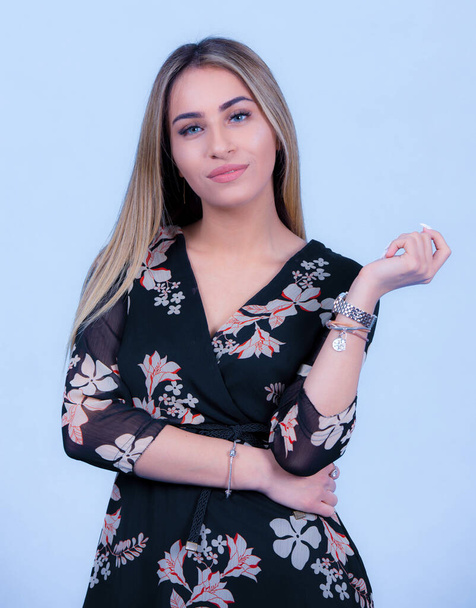 portrait Attractive young blonde model posing in trendy dress isolated at blue studio background. Beautiful girl standing in trendy clothing looking at camera, - Foto, afbeelding