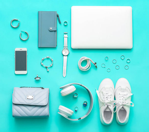 Female accessories with laptop, headphones and mobile phone on color background - Photo, Image