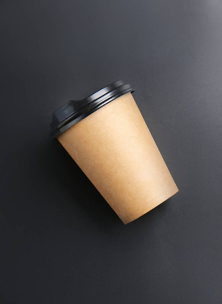 Takeaway cup for drink on dark background - 写真・画像