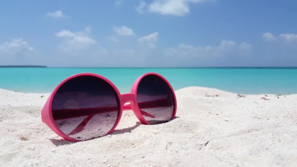 Pink sunglasses on the beach. Idyllic nature of Bali. - Footage, Video