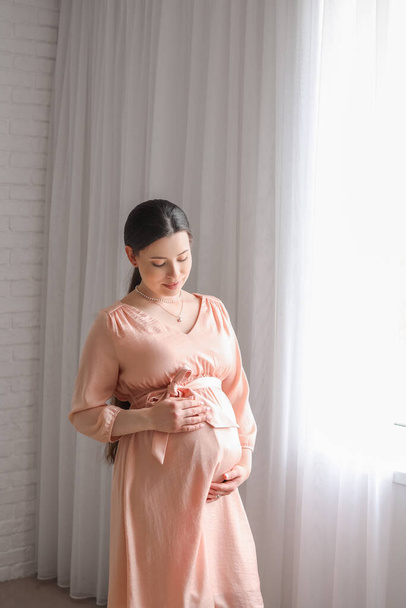 Beautiful pregnant woman at home - Fotó, kép