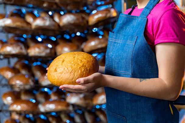 Woman holding tasty fresh bread, close up - Photo, Image