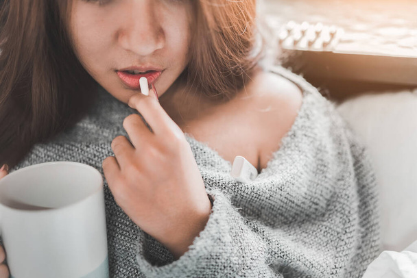 Doente mulher asiática tem gripe febre alta e tomar remédio na cama no quarto, conceito médico e de saúde, foco seletivo. - Foto, Imagem
