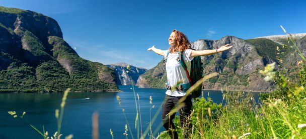 Woman emotional raised hands Travel adventure Lifestyle wanderlust concept vacations outdoor success walk in Norway - Zdjęcie, obraz