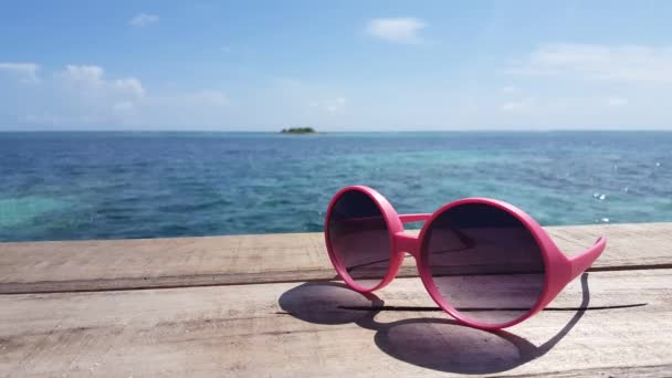 Sunglasses with sea on the background. Nature of Bali, Indonesia. - Footage, Video
