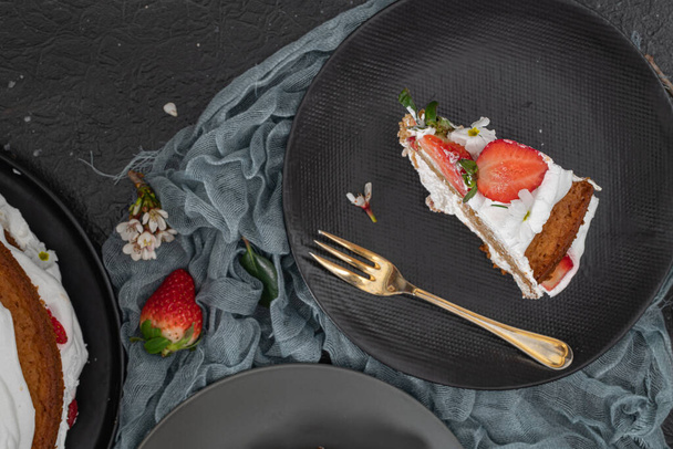 Strawberry cake, strawberry sponge cake with fresh strawberries and sour cream on a dark background - Photo, Image