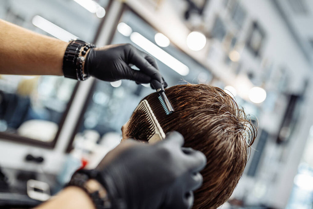 Thinning and styling hair. Hairdresser makes a haircut to the client.  - Valokuva, kuva