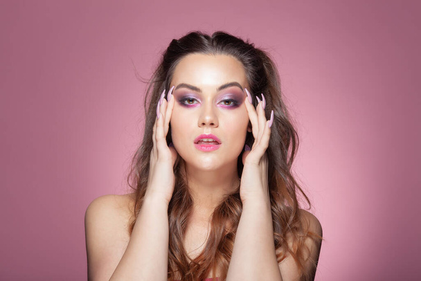 Portrait of a young sexy woman. Studio shoot on pink background. - 写真・画像