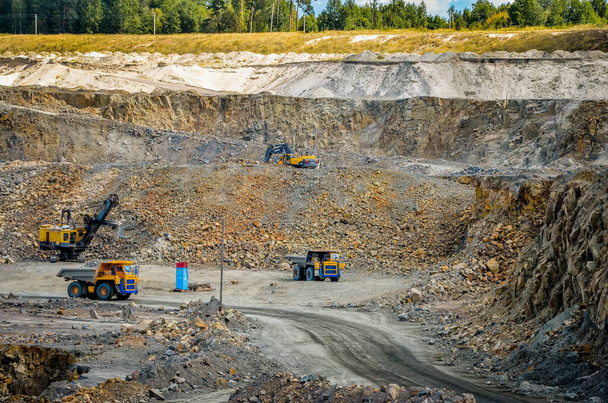 Zhodzina, Belarus - August 16, 2013: Granite mining in Quarry Trucks quarry of BelAZ producer - Фото, изображение