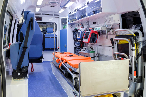 Inside an ambulance car with medical equipment for helping patients before delivery to the hospital. - Foto, imagen