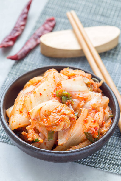 Kimchi cabbage. Korean appetizer in a ceramic bowl, vertical - Photo, Image