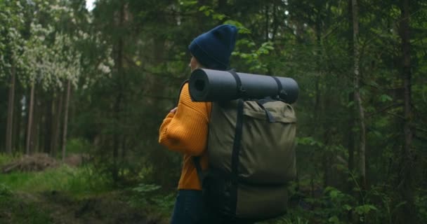 Close up back of woman with backpack walking at the autumn forest nature landscape travel weather tree outdoor woods slow motion. - Footage, Video