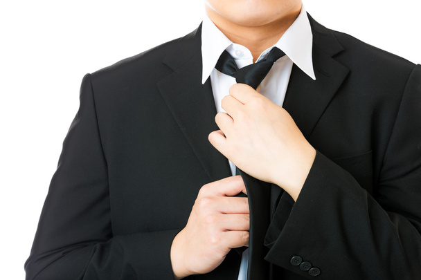 Businessman adjusting tie isolated on white - Photo, Image