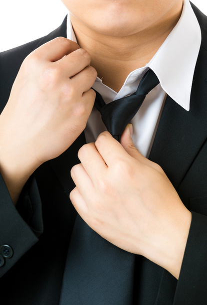 Businessman adjusting tie - Foto, imagen