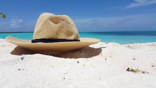 Straw hat on beach sand. Enjoying summer vacation on Bali, Indonesia. - Footage, Video