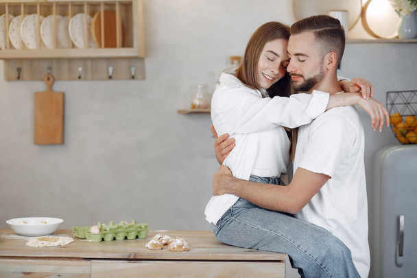 Beautiful couple spend time in a kitchen - Zdjęcie, obraz