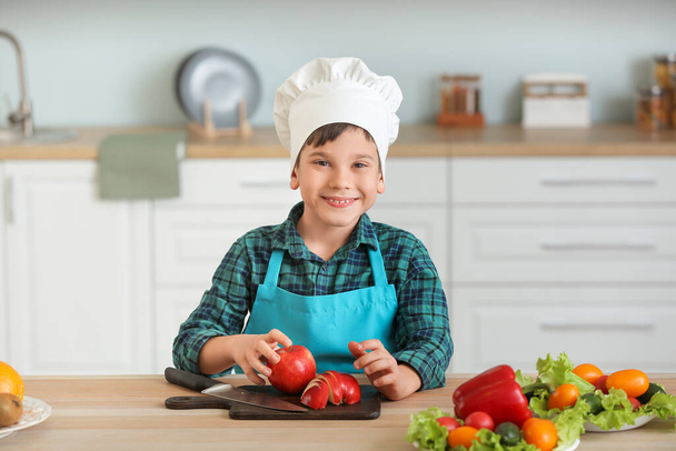 Cute little chef cooking in kitchen - Foto, Imagen