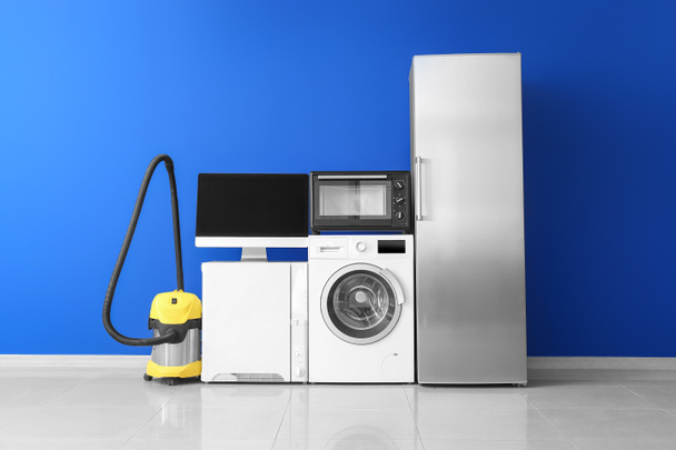 Different household appliances near color wall - Photo, Image