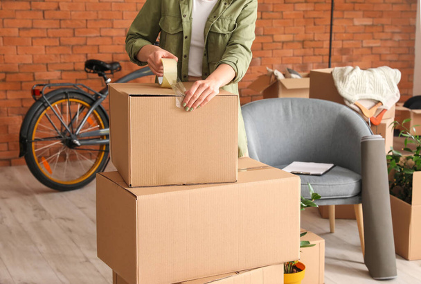 Woman packing moving box at home - Photo, Image