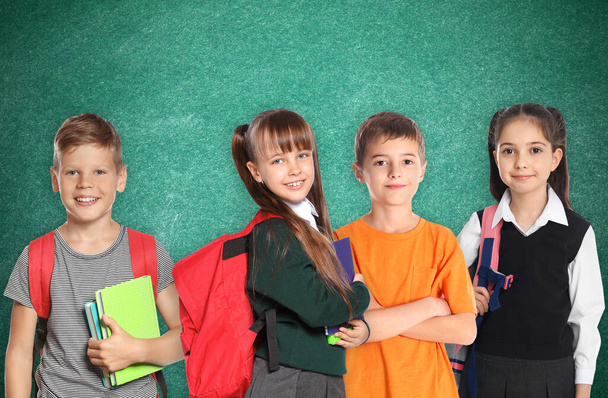Group of cute school children and chalkboard on background - Φωτογραφία, εικόνα