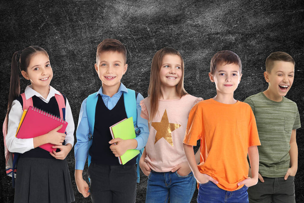 Group of cute school children and chalkboard on background - Фото, зображення