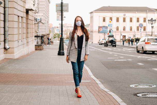 Covid-19 and Air pollution pm2.5 concept. Pandemic, portrait of a young woman wearing protective mask on street. Concept health and safety - Fotó, kép