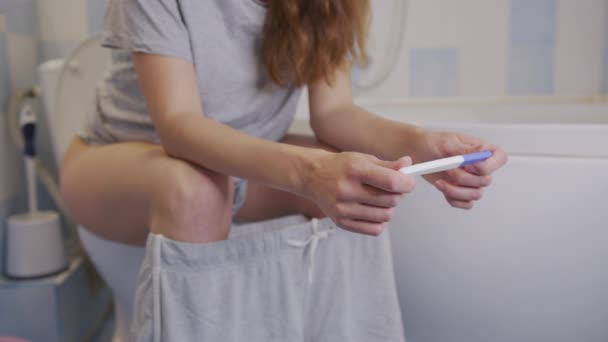 Terhességi tesztet tartó nő a kezében. - Felvétel, videó