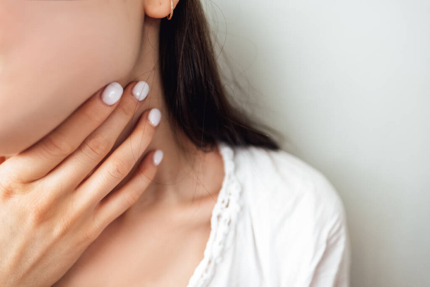 Sore Throat. Closeup Of Beautiful Young Woman Hand Touching Her Ill Neck.  - 写真・画像