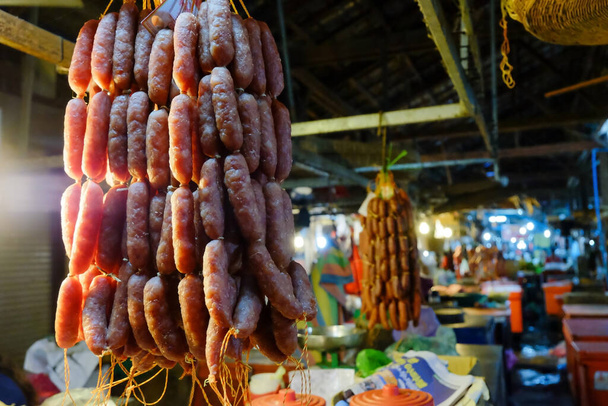 homemade sausages on a rope for sale at a farmers market. - Фото, изображение