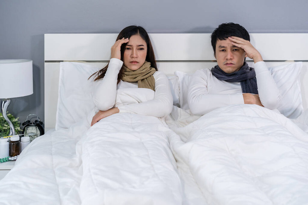 sick couple headache and suffering from virus disease and fever on bed at home - Photo, Image