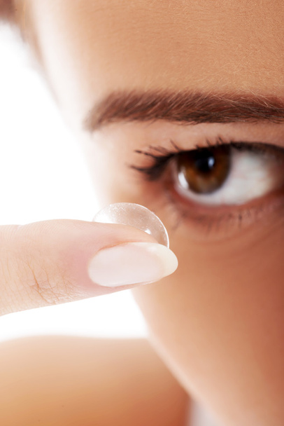Close up on woman putting lens into eye. - Fotografie, Obrázek