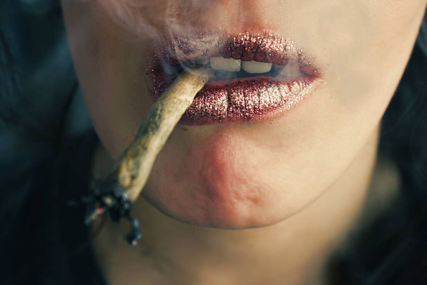 Female lips smoking self-roll weed cigarette. Close-up, lips and fume - Foto, immagini
