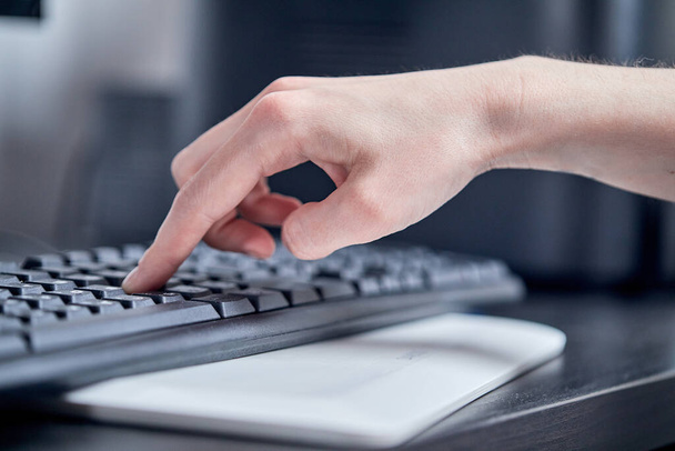 office worker female hand typing on keyboard, close view  - Fotó, kép