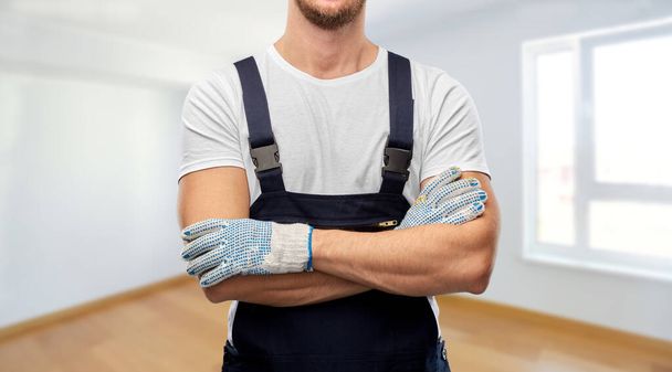 close up of male builder in overall and gloves - Фото, изображение