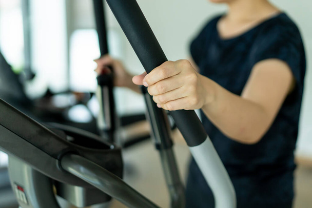 Asian fat woman using exercise machines in indoor gym, sport Asian woman's portrait with copy space. - Foto, Bild