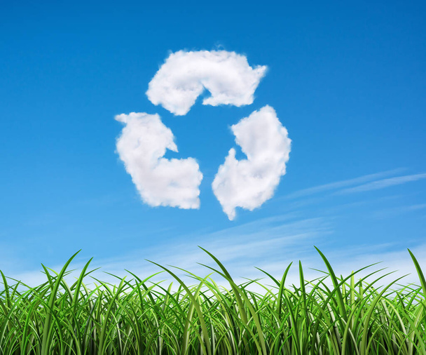 Clouds on the blue sky in shape of the symbol of recycling on green background. Protection nature and future concept. - 写真・画像