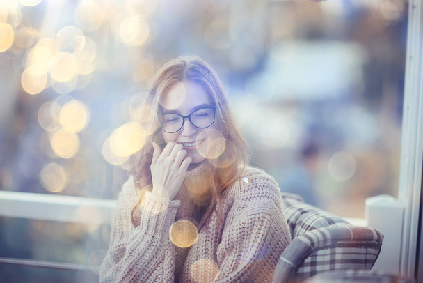 happy girl autumn cafe sweater concept vision model with glasses posing - 写真・画像