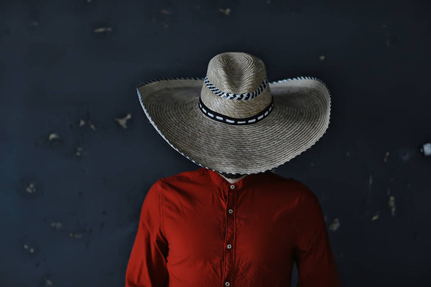 stern cowboy in a hat with brim, straw, retro vintage style, angry man wild west western - Fotografie, Obrázek