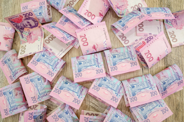 200 гривен фон. много украинских денег
. - Фото, изображение