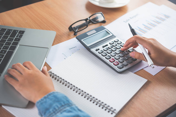 The accountant's hand is using the calculator. For cost analysis Profit and loss and tax calculation concept preparation of financial statements - Fotoğraf, Görsel