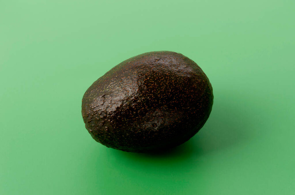 Avocado on a green background - Photo, Image