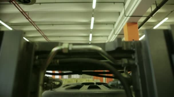 Manual worker operating forklift to move boxes and parcels - Materiał filmowy, wideo