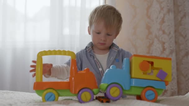 здоровий щасливий усміхнений чоловік дитина з благополуччям весело грає зі своїми пластиковими іграшками безпеки
 - Кадри, відео