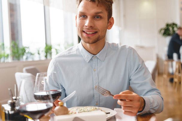 Handsome young man spending time in restaurant - Foto, Imagem