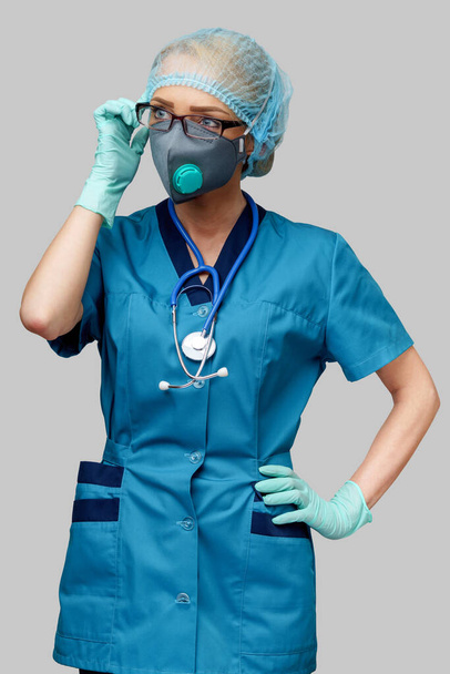 female doctor with stethoscope wearing protective mask and latex gloves over light grey background - Photo, Image