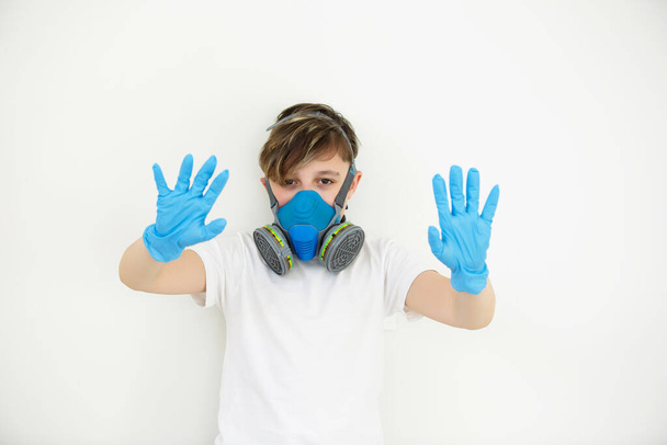 The boy in respirator. protection. Safety breathing mask. Protect corona virus. Breathing respirator mask. Latex gloves.Flat on white backdrop. Breathing respirator mask. Pandemic risk - Foto, imagen
