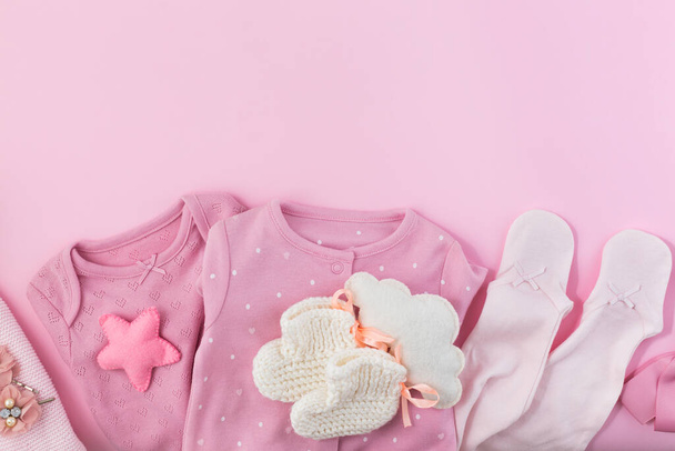 baby clothes and diapers isolated on color background. - Zdjęcie, obraz