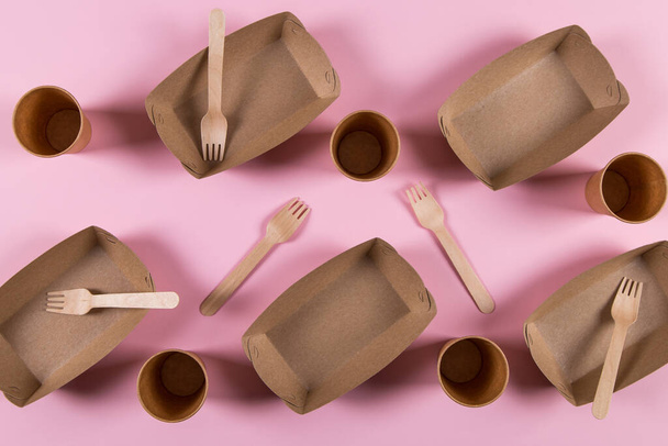 Paper eco-friendly utensils, without contamination, for reprocessing, brown on pink background. - Fotó, kép