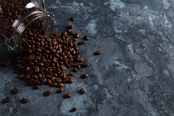 Coffee crumbled from a jar, on a dark concrete background. - 写真・画像
