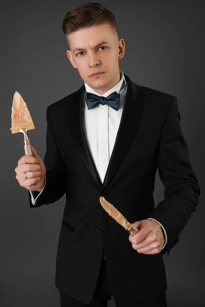 Portrét atraktivního mladého podnikatele v černém pozadí v obleku a kravatě. Klasický styl. Studio shot - Fotografie, Obrázek